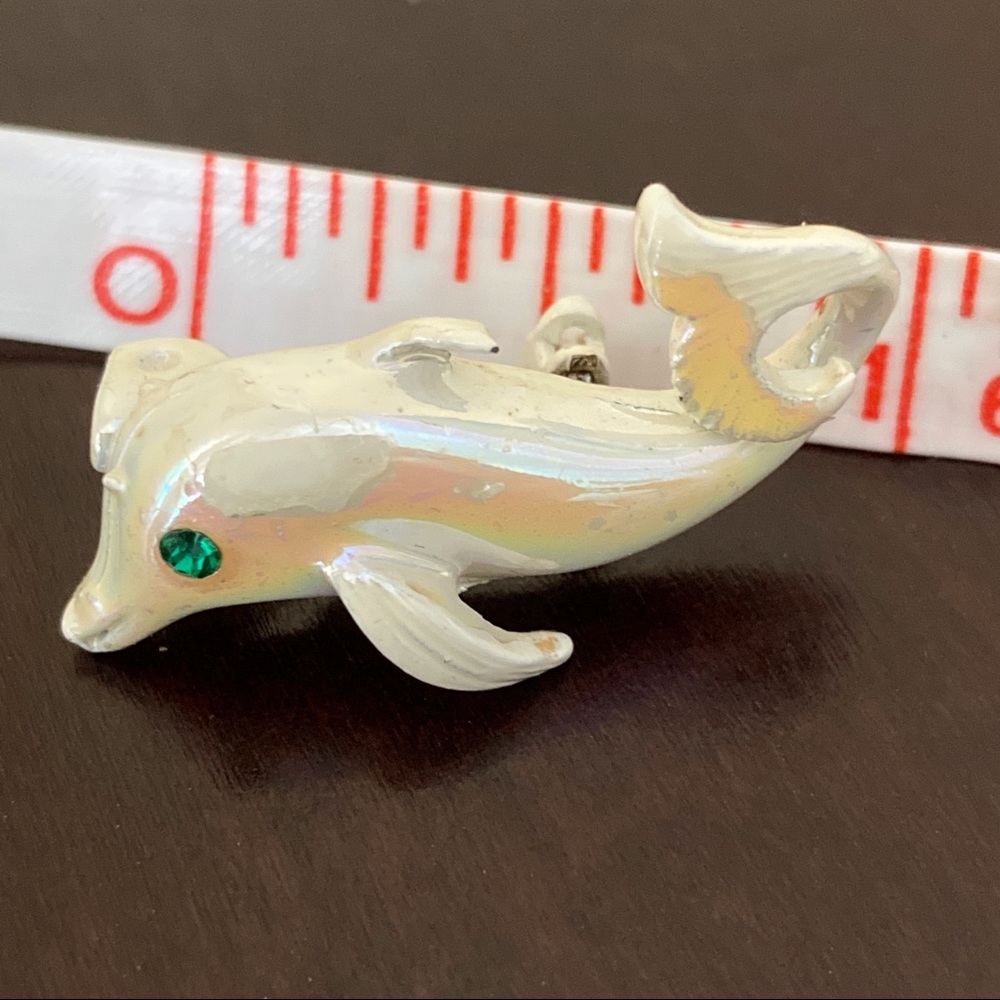$2/$15, 3/$20 Tiny pearlescent white dolphin with emerald eye